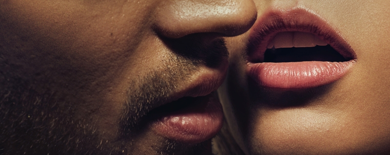 Heterosexual couple. Close up to their mouth, open lips signifying lust